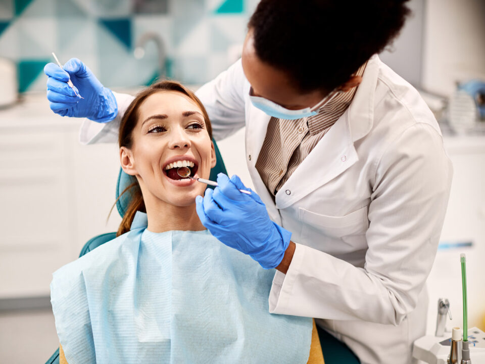 Woman getting dental examination by a female dentist