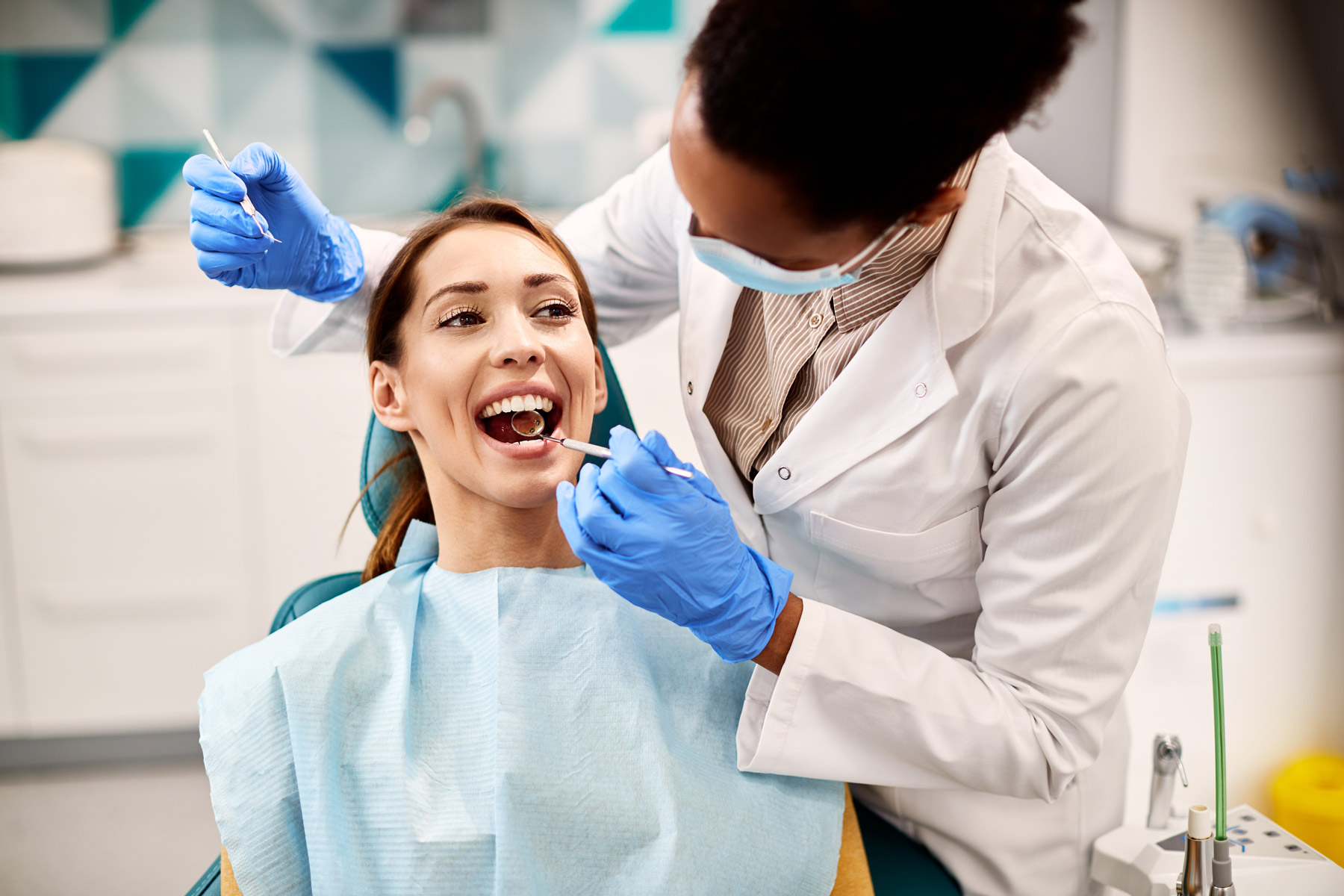 Woman getting dental examination by a female dentist
