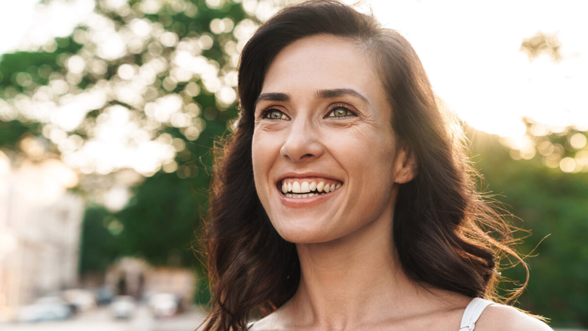 middle aged woman smiling in the street