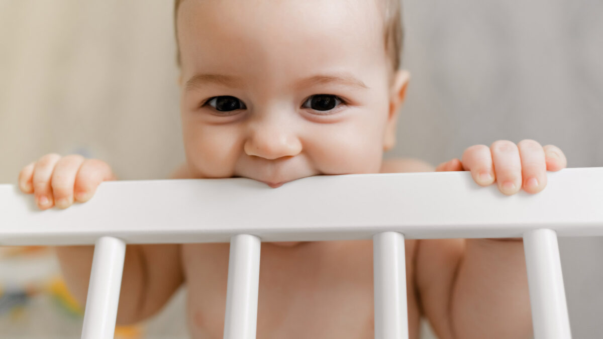an infant biting bed frame