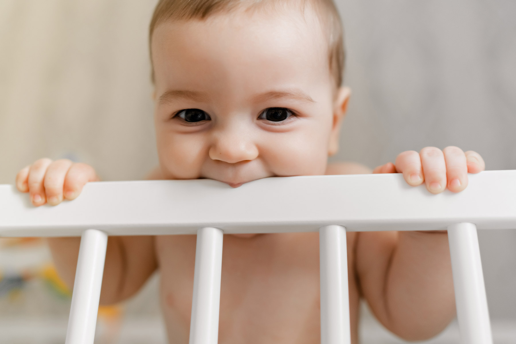 an infant biting bed frame