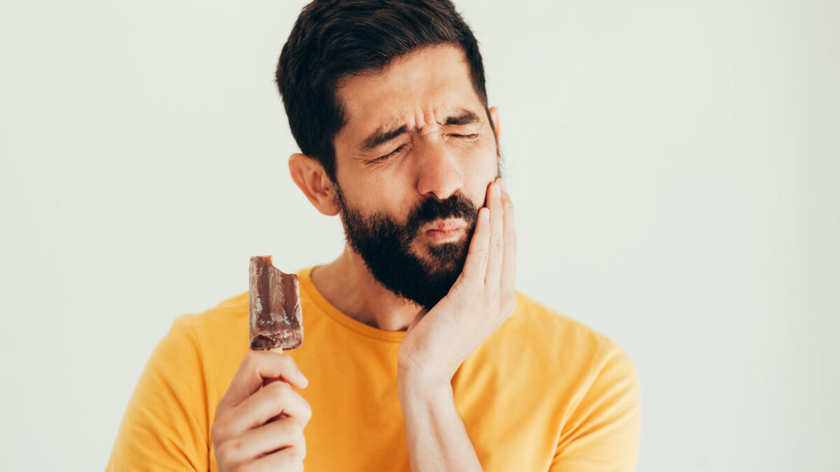 a man with sensitive teeth eating ice cream