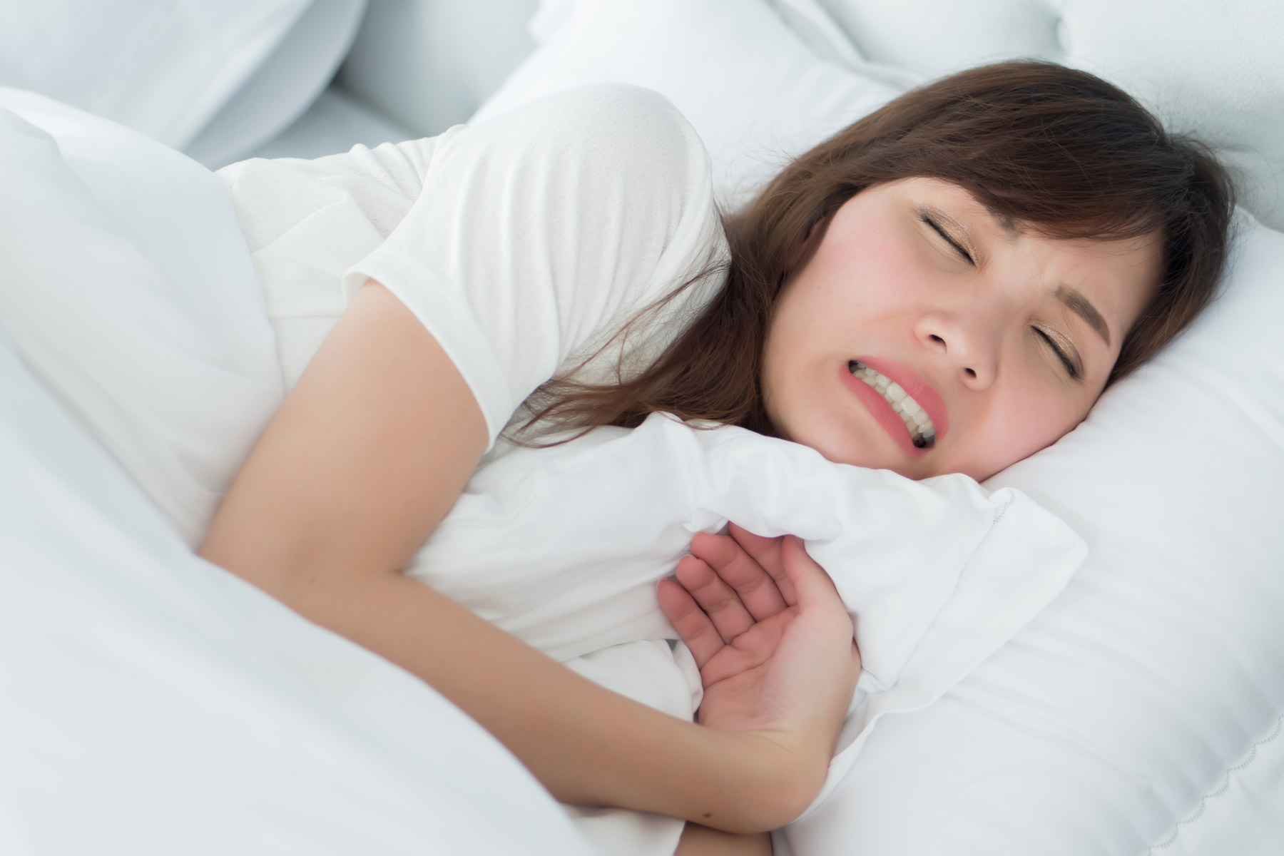 a woman suffering from bruxism in her sleep