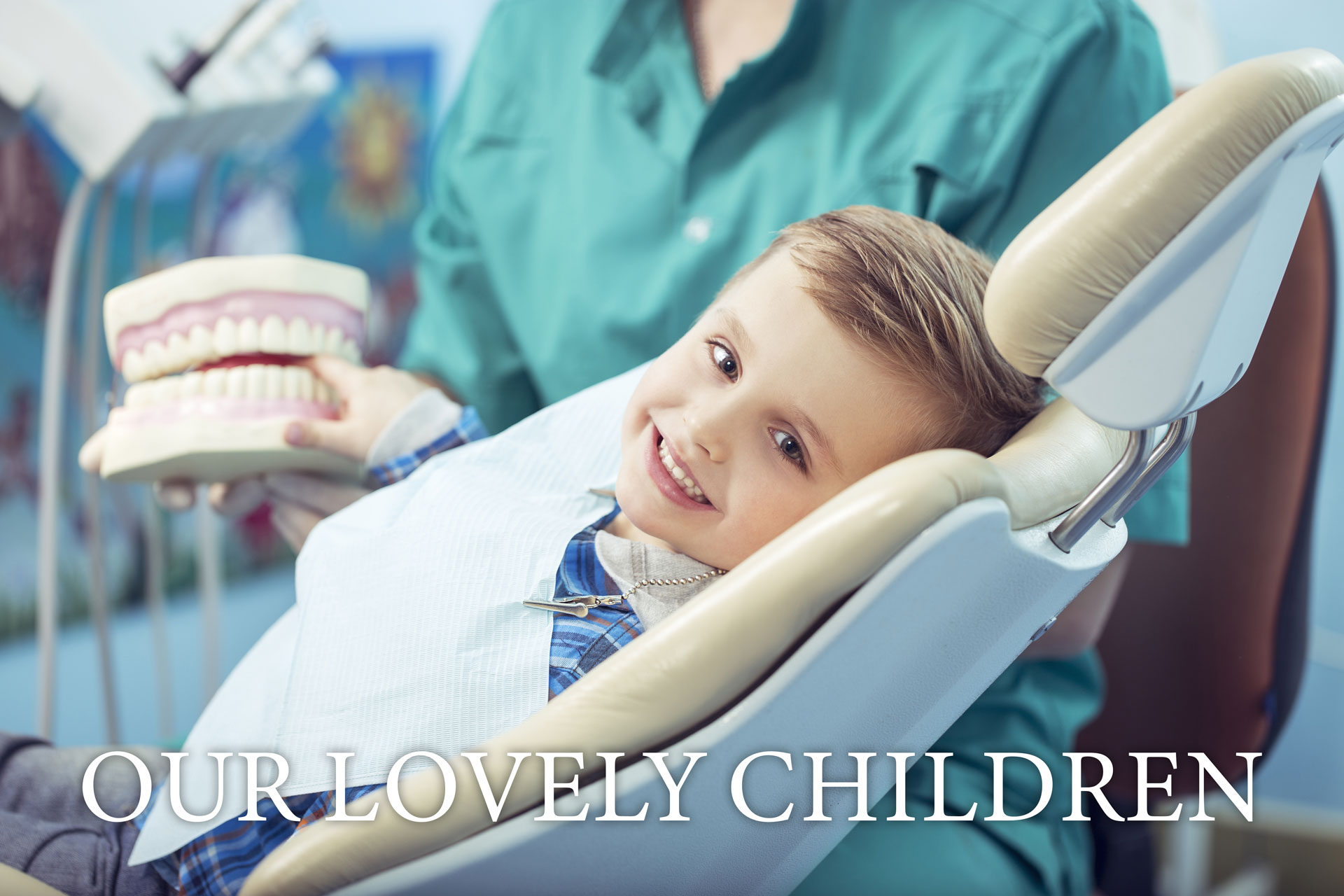 happy little boy visiting pediatric dentist on dental unit
