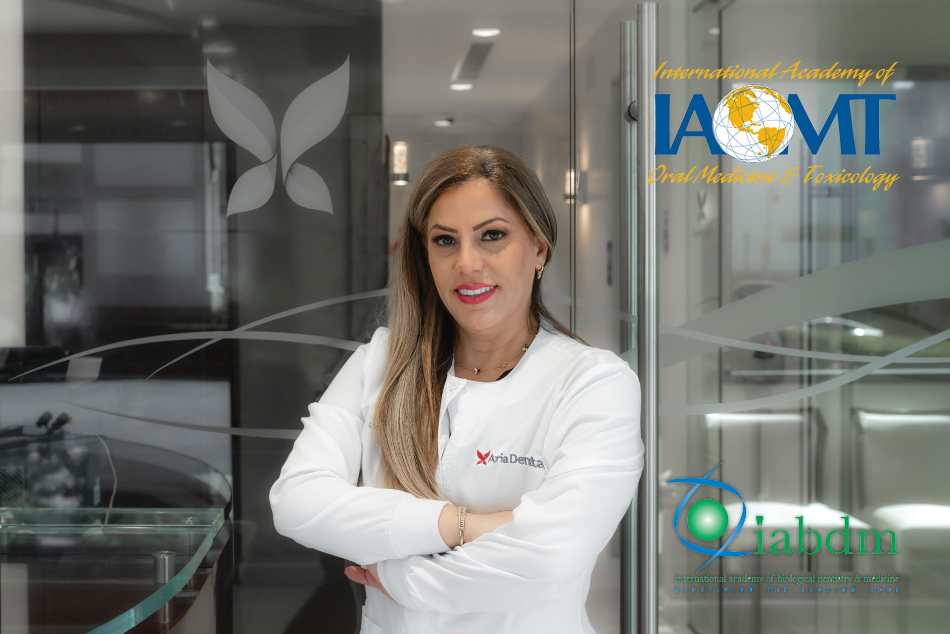 Dr. Maryam Horiyat in office and IAOMT logo on top right