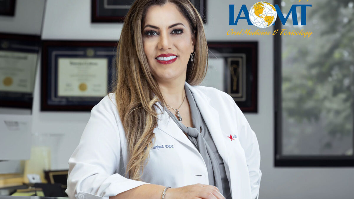 Dr. Maryam Horiyat in office with IAOMT logo on top right