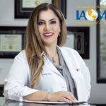 Dr. Maryam Horiyat in office with IAOMT logo on top right