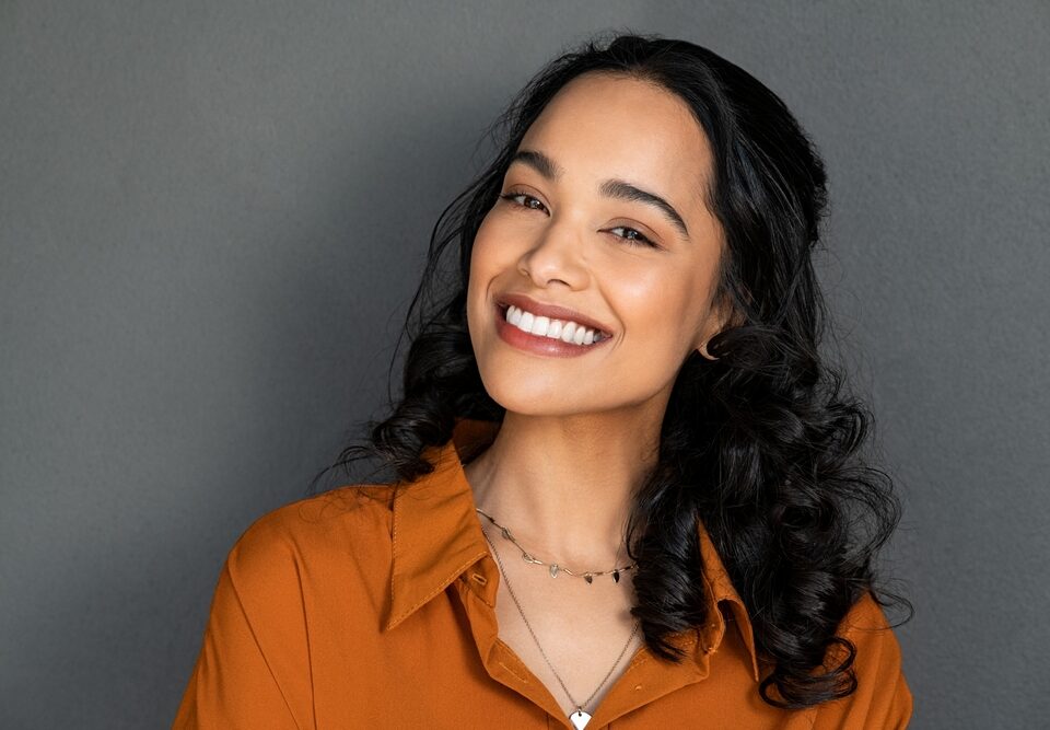 What To Expect From Small Dentist Offices Near Me 14 young women smiling for a dental photo, grey background