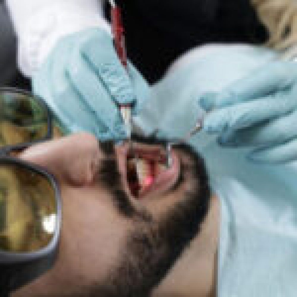Dr. Maryam Horiyat examining male patient at Aria Dental