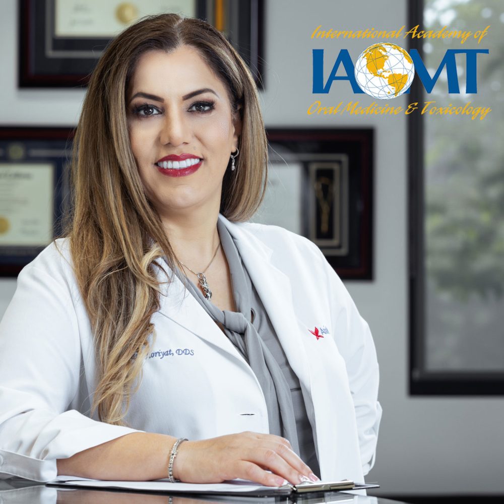 Dr. Maryam Horiyat in the office with IAOMT logo on top right on the image